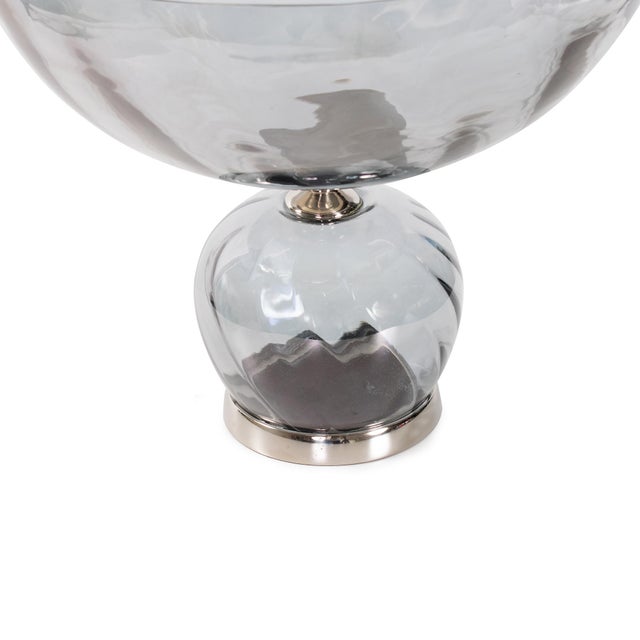 With its subtle smoky hue, faceted texture, and gleaming nickel base, this piece brings refined sophistication to any...