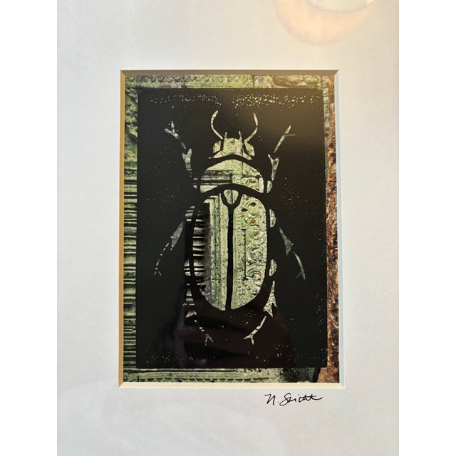 This original beetle print features a hand-carved block impression layered over subtle green-toned imagery, giving the...
