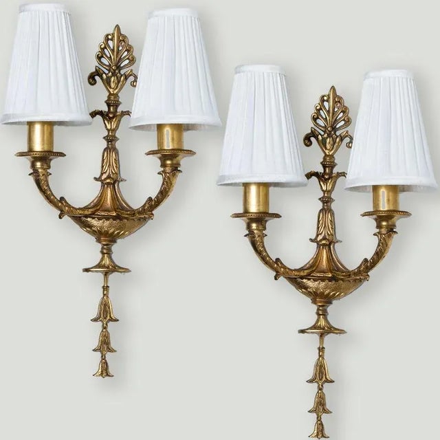 An exceptional antique pair of French bronze Louis XVI wall sconces. The antique sconces are heavy cast bronze. with off...