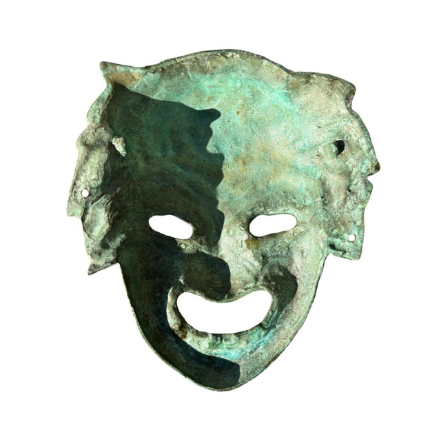 A vintage bronze wall mask. It has been made from cast bronze, with a verdigris patina. It features the face of Dionysos,...
