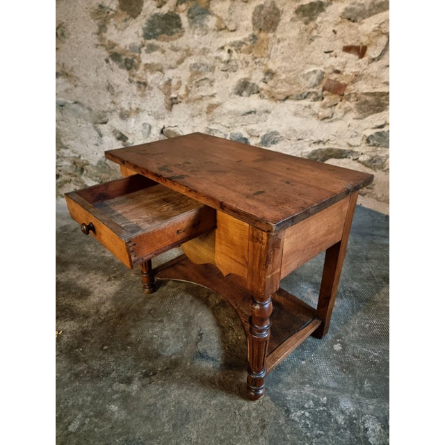 Elegant antique French side table dating from the mid-19th century, beautifully crafted from solid walnut and cherry wood....