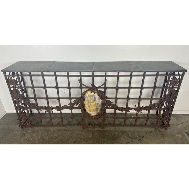 This monumental hand-wrought iron console table showcases exceptional architectural presence and craftsmanship. The...