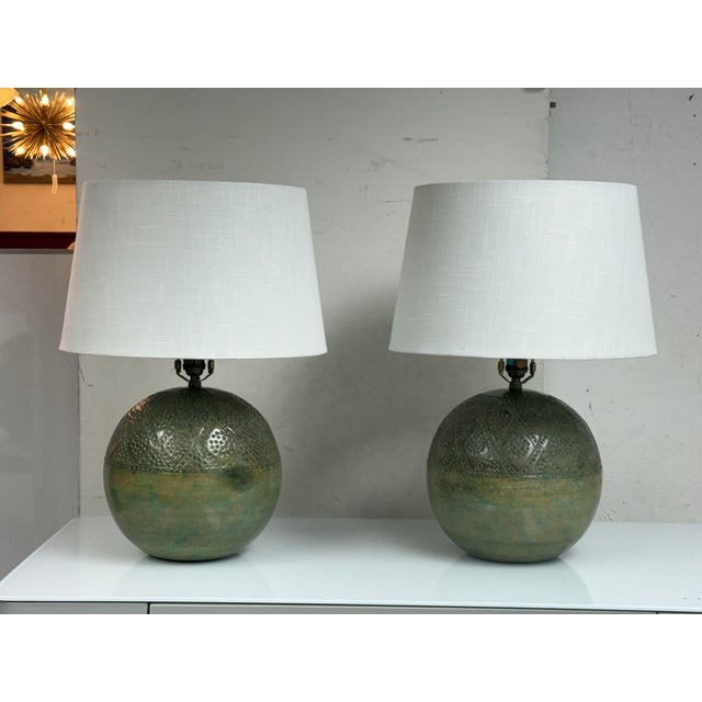 Design Plus Gallery presents a Pair of Pair of Moroccan Revival Table Lamps. These lamps have rounded bodies with an...
