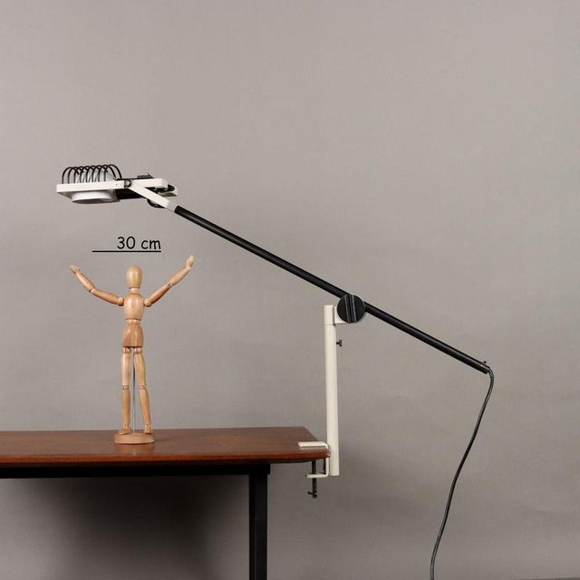 Table lamp with clamp, in enameled metal and aluminum. E27 lamp. This piece is attributed to the mentioned designer/maker....