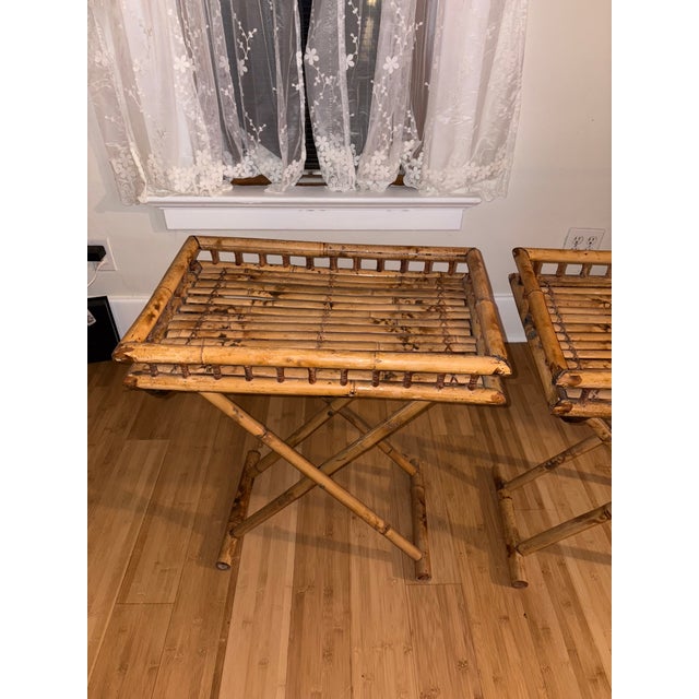 Two separate bamboo butler tables. Foldable, measuring 24x16x28, good condition with little to no discoloration.