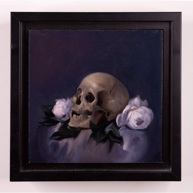This oil on canvas piece features a skull positioned among softly rendered roses, creating a striking contrast between...