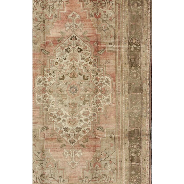 Measures: 7'4 x 12'5 Vintage Turkish Oushak Rug With Faint Salmon Field and Floral Motifs 7'4 x 12'5. Keivan Woven Arts /...