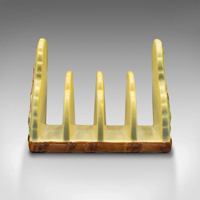 This is a vintage decorative toast rack. An English, ceramic 4-slot breakfast stand, dating to the mid 20th century, circa...