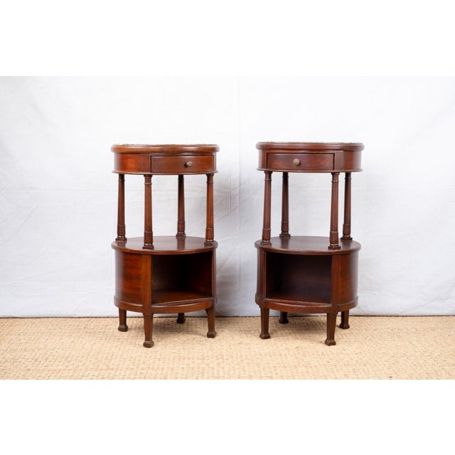 A pair of tall round sides tables, early 19th century, French. Thought to be used as side tables or bedside tables for a...