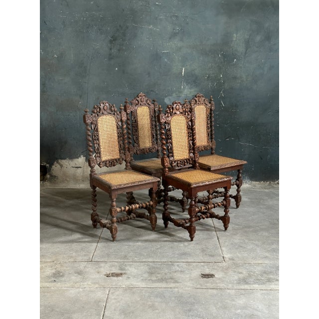 Very nice set of four French Henri II style side chairs heavily carved featuring leafs, flowers, vines, and barley twist...