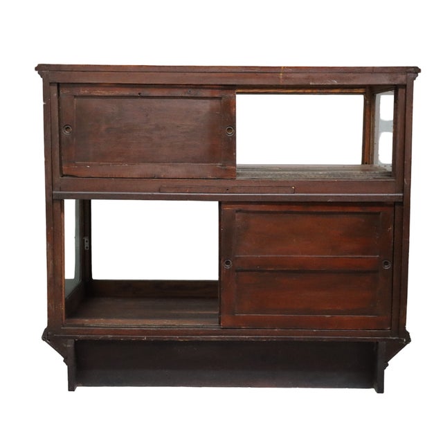 Antique oak and glass country store candy showcase, circa 1910, unsigned. The rectangular countertop display case has...