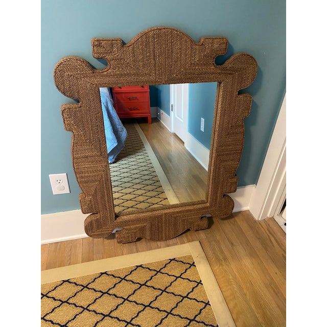 The Mowgli mirror from Arteriors Home features a frame wrapped in tobacco stained abaca, known for its durable fibers....