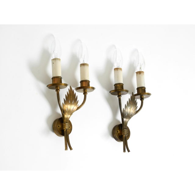 Two beautiful, rare mid-century modern brass wall lamps by vereinigte werkstätten. made in germany. A stunning design in...