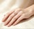 Elegant 14K pink rose gold eternity wedding band featuring brilliant round diamonds totaling 0.6 carats. Estate piece with...