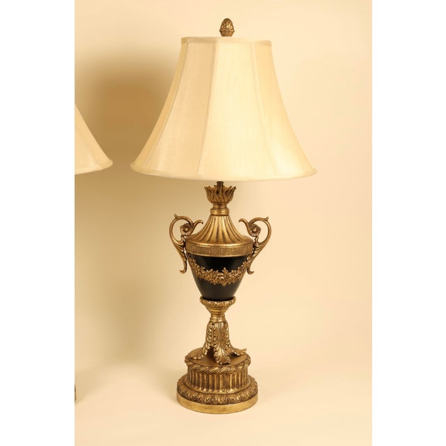 A magnificent pair of large-scale, Neoclassical Empire style table lamps. The central amphora/urn-shaped body beautifully...