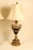 A magnificent pair of large-scale, Neoclassical Empire style table lamps. The central amphora/urn-shaped body beautifully...