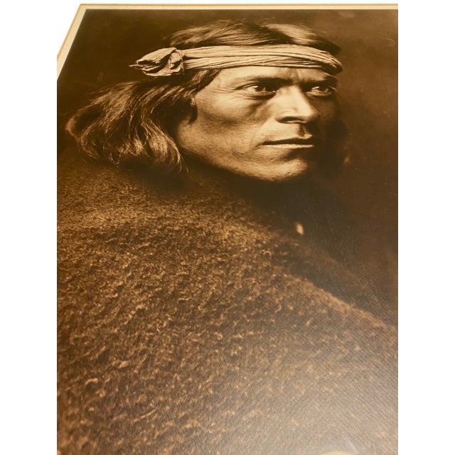 This is a striking framed photographic print of "A Zuni Governor," one of Edward S. Curtis's best-known portraits,...