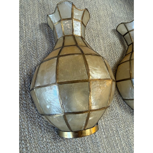 A sculptural pair of Italian wall sconces from the 1970s, beautifully crafted in the form of stylized vases. Each piece is...