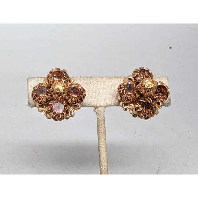 1960s goldtone filigree bead center with four prong set round faux-topaz around it butterfly clip back earrings. Marked...