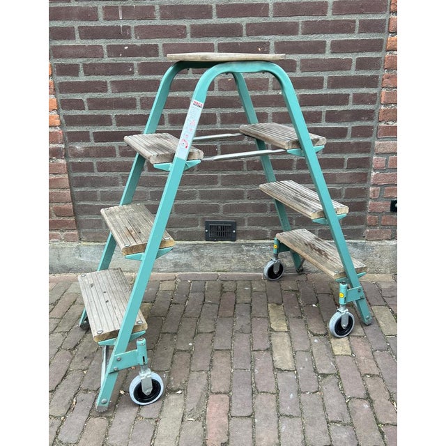 Industrial rolling and decorative step ladder. MATERIAL: Wood and metal. Tough and beautiful old warehouse ladder on...