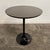 Mid Century Modern Burke Round Tulip Bistro Table. This table features a metal tulip base with a laminate covered top made...