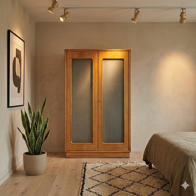 A double-door wardrobe with an open side niche and glass shelf, and an interior drawer unit. It features a maple veneer, a...