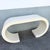 Striking vintage Postmodern console table featuring a dramatic continuous scroll silhouette finished in cream gloss...