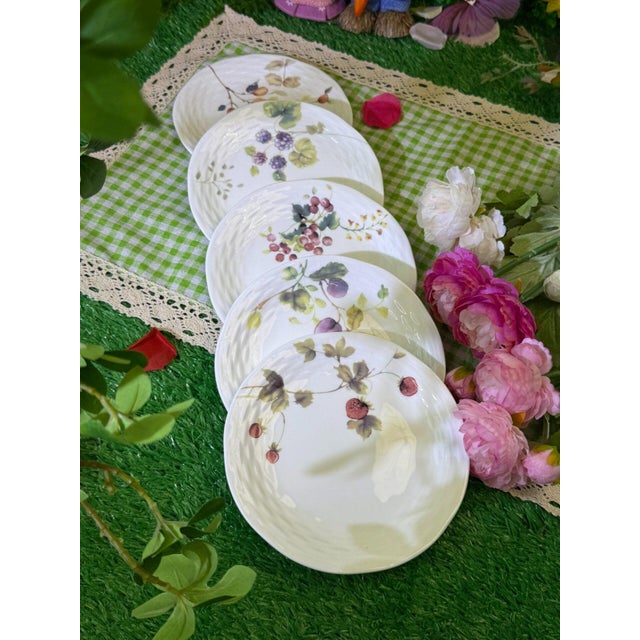 This is a set of four ceramic plates featuring exquisite floral patterns. These plates are a wonderful way to add color...