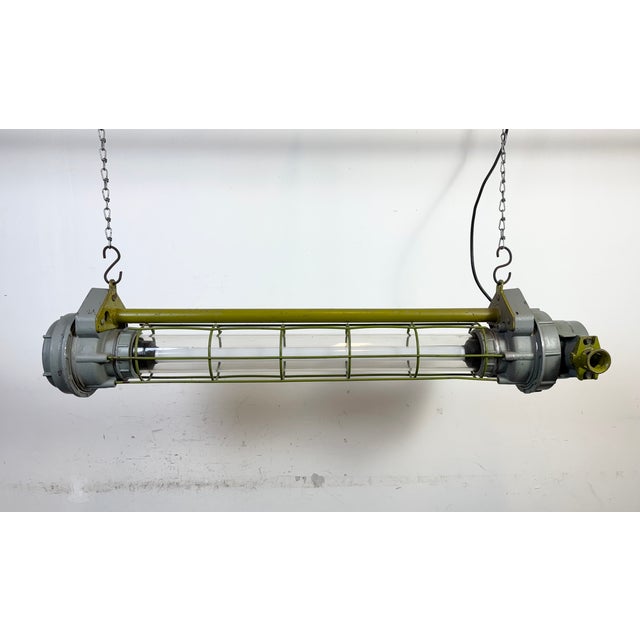 This green grey industrial tube light was made in Ukraine in former Soviet Union during the 1970s. It is made of an...