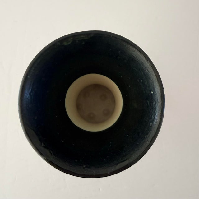 A striking example of early 20th-century Dutch art pottery, this hand-painted Schoonhoven vase features an elegant...