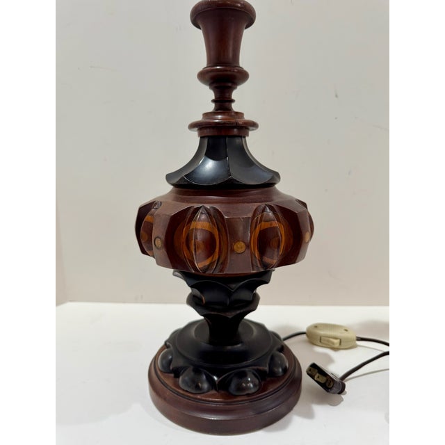 Vintage table lamp with tall turned standard and dramatic carved and inlaid wood body. Decorative geometric marquetry...