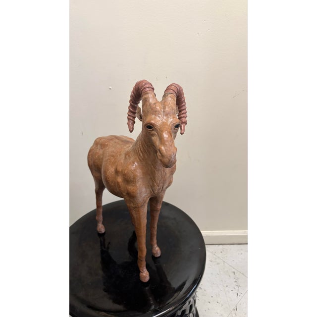 Statement leather wrapped American ram. Beautiful accent for any interior space. It features a tight leather wrap...