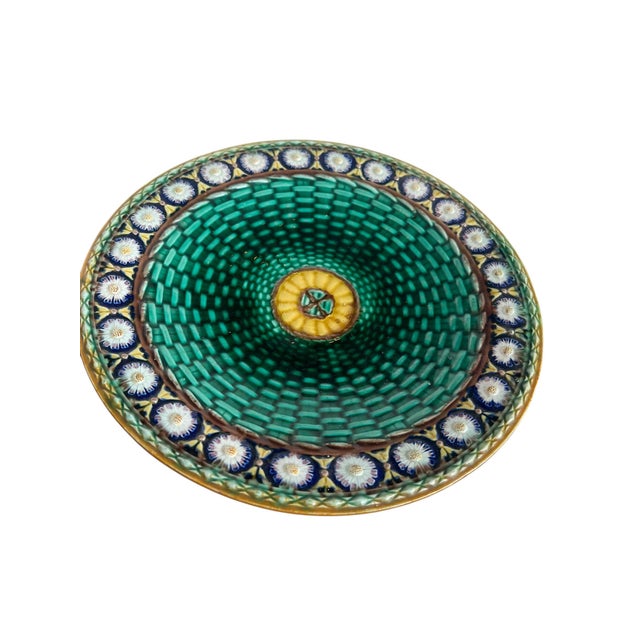 A richly detailed example of English majolica by Wedgwood, this striking plate features a vivid emerald green basketweave...