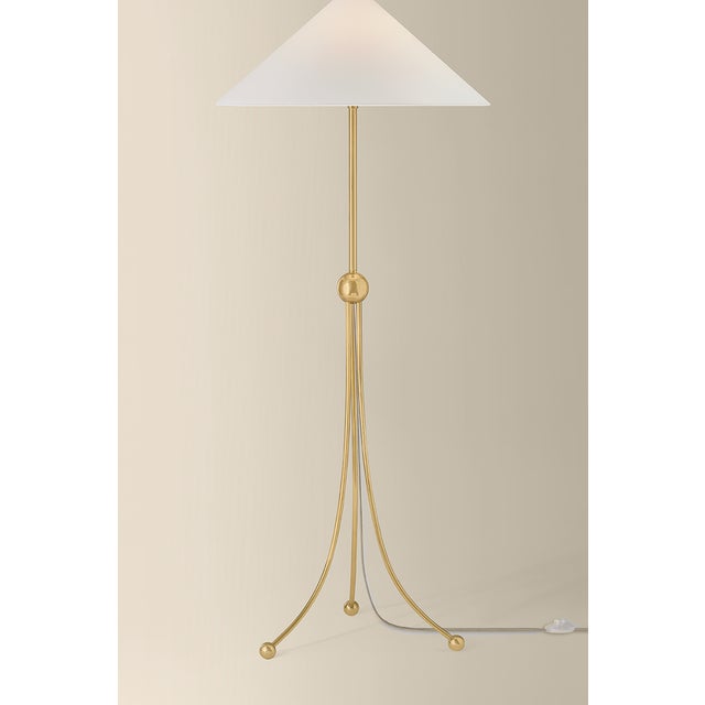 Statuesque and expressive, the Katya floor lamp adds graphic elements to an elongated form. Three curved legs with...