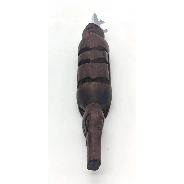 Offered is a vintage handcrafted carved African wood chiseled crocodile fashioned with a stainless steel bottle-cap...