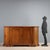 Baroque walnut sideboard with a rounded shape. Front with a pair of paneled doors, three drawers added later. Bracketed...