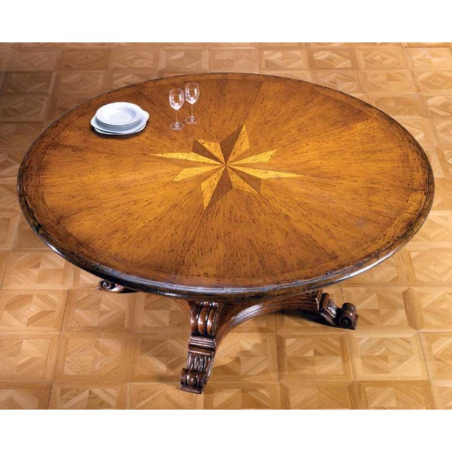 Handcrafted in Italy from solid walnut, this round dining table features a decorative sunburst inlay crafted from...