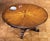 Handcrafted in Italy from solid walnut, this round dining table features a decorative sunburst inlay crafted from...