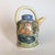 A Laura Wilensky studio ceramic teapot with applied and relief decorations depicting bunnies at home and swimming in a...