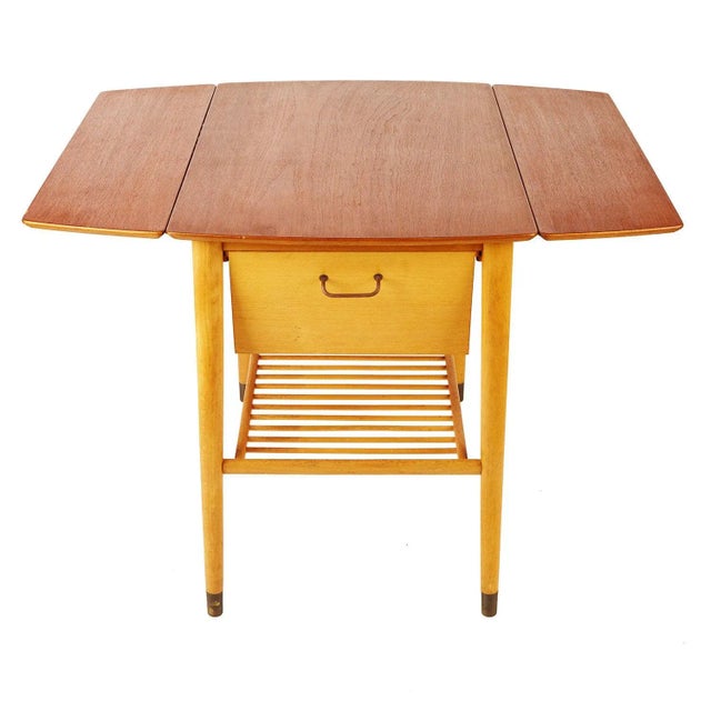 Teak drop-leaf wine table with unique birch drawer inserts. Holds 3 bottles of wine and six stem glasses. With spindle...