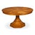 Warm-toned oak and a faceted column bring geometric structure to the dining room. A single faceted pedestal tapers from a...