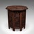 This is an antique campaign tea table. An Anglo-Indian, carved hardwood lamp or side table dating to the late Victorian...