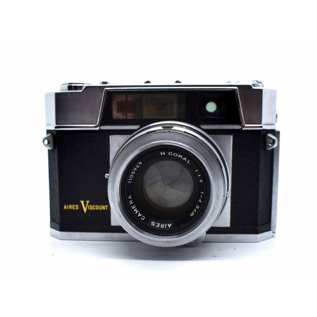 Elevate your bookshelf or office desk with this striking Aires Viscount 35mm rangefinder camera, a prime example of late...