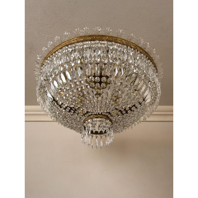 Vintage Empire-style ceiling light, made in Italy in the 1950s, embellished with cut Bohemian crystals. The brass frame,...