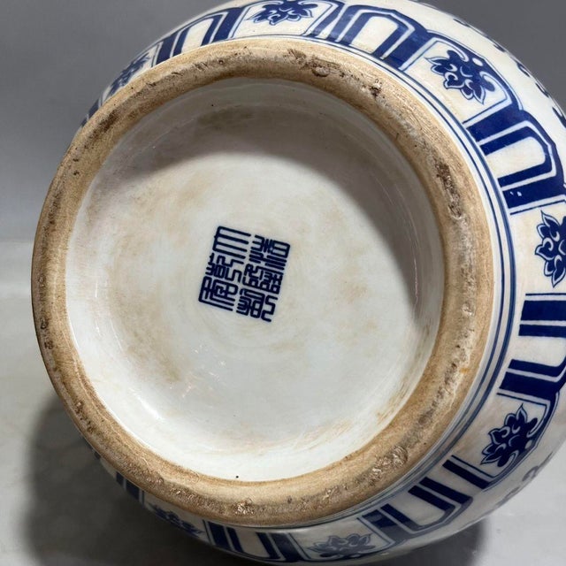 This impressive blue and white porcelain vase is a magnificent example of traditional Asian ceramic artistry. The body is...