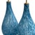each shapely lamp of hand-blown sky blue dappled glass all raised on a brass and lucite circular base; height: 17.75" (top...