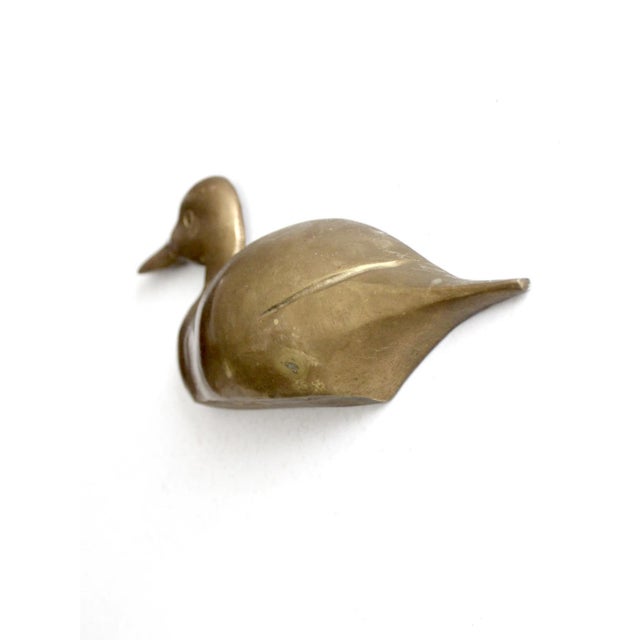 This mid-century brass duck wall hanging features sleek modern lines and a rich natural patina. The brass sculpture adds...
