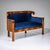 Biedermeier two-seater sofa veneered in walnut, standing on column legs with ebonized capitals. The gently curved backrest...