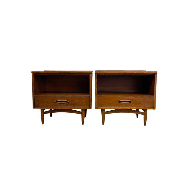 This matching pair of mid-century modern end tables features clean architectural lines paired with subtle sculptural...