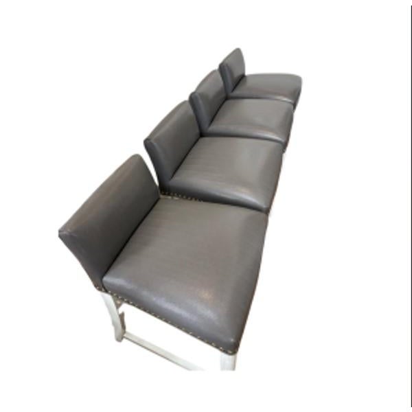 Set of 4 grey leather counter stools with nailhead trim. White legs. Brand new condition!! Size is 32H X 20.5DX 20W X...